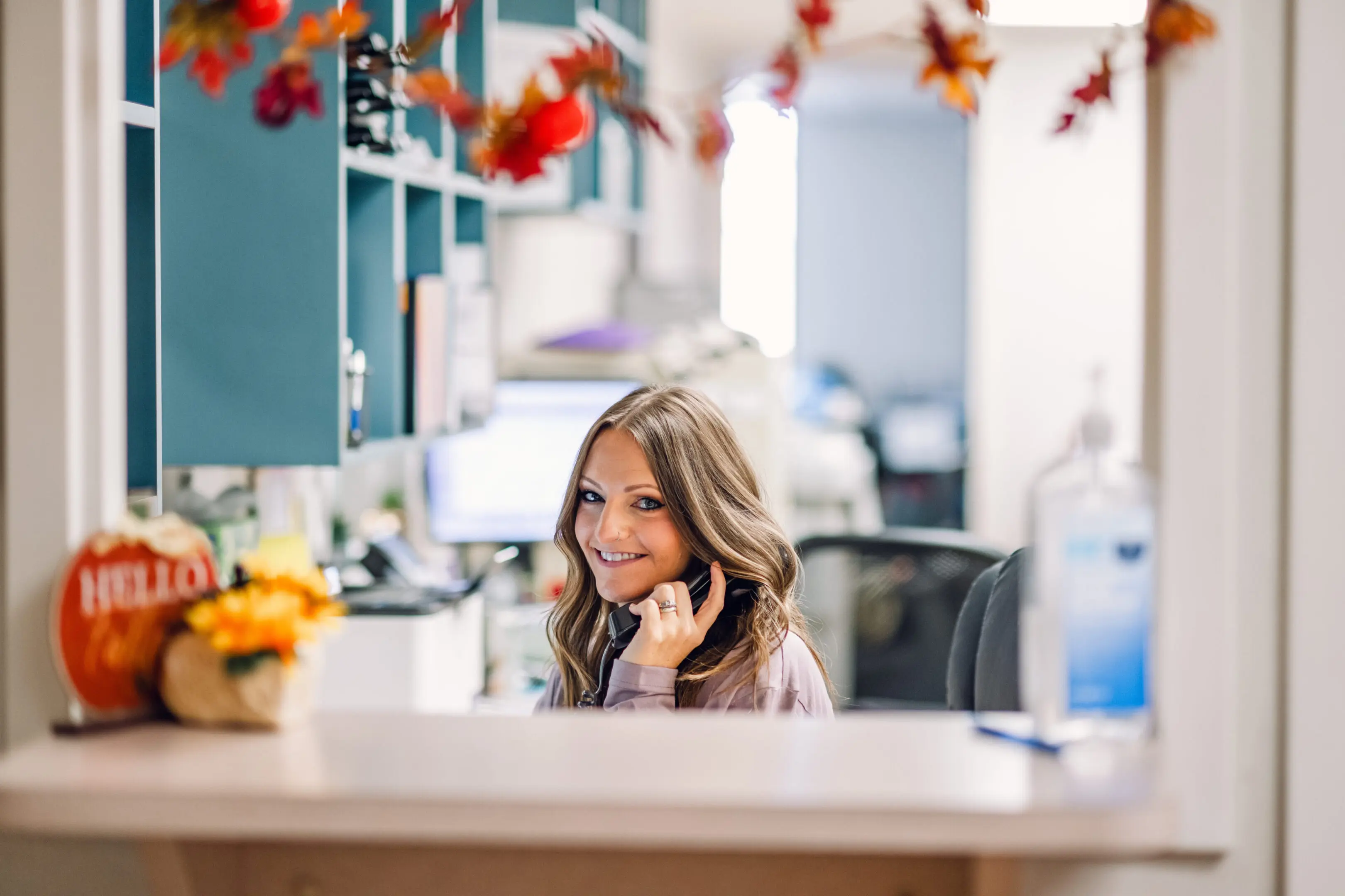 Smiling woman working in a bright office space.